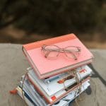 eyeglasses on stack of books